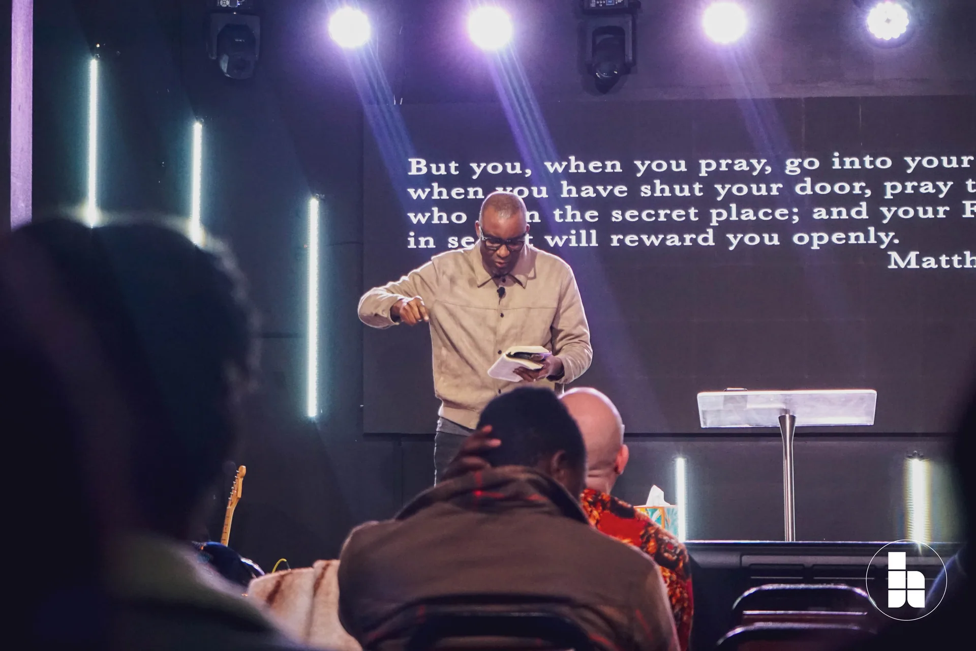 A pastor teaching from Scripture during a Sunday service